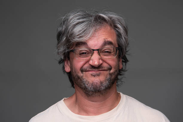 istock Smiling Mature man looking at the camera on  gray background 2160485282