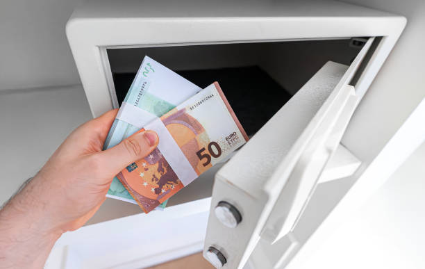 istock Man puts or takes euro banknotes from a safe. 2160488788
