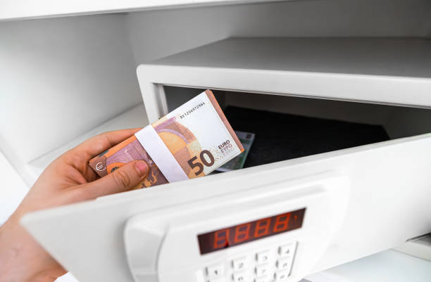 istock Man puts or takes euro banknotes from a safe. 2160488797