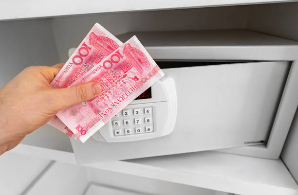 istock Man puts or takes chinese ancestor money from a safe. 2160488841