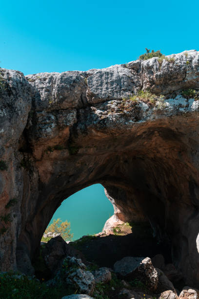 istock Lake and sky view from the exit of the cave in the mountain 2160490286