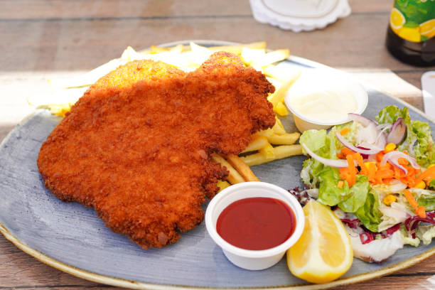 German Wiener schnitzel ( Schnitzel mit Pommes Frites ) at beer hall in Germany