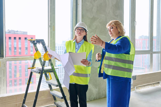 istock Two female industrial workers at construction site discussing work plans 2160492621
