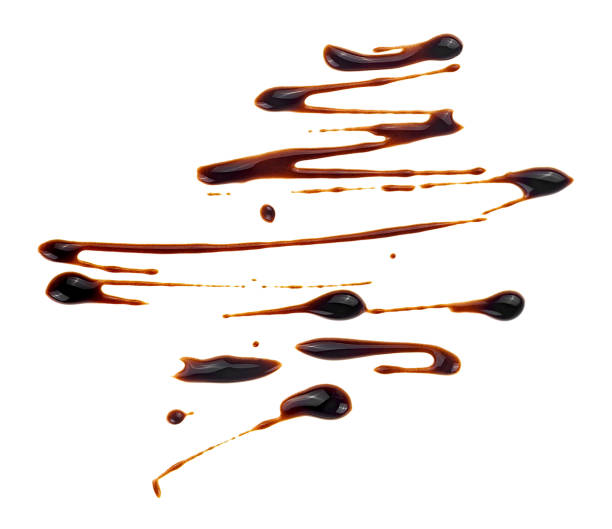 istock Liquid chocolate sauce isolated on a white background. Melted chocolate cream. 2160494226