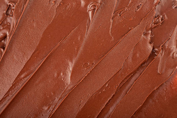 istock Melted chocolate cream as background, top view. Hazelnut cream, chocolate smear. 2160494256