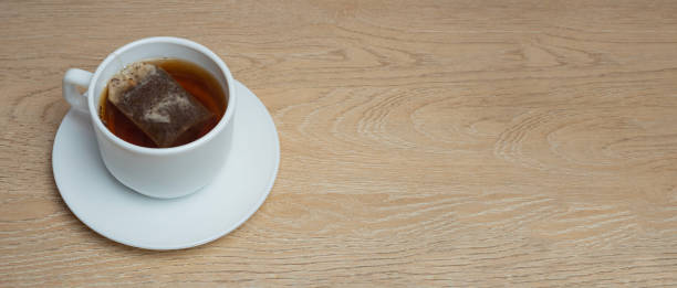 istock cup of tea on a wooden background. copy space 2160494347