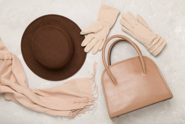 Stylish autumn accessories on concrete background, top view