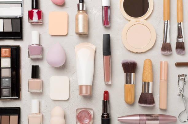 istock Flat lay with makeup products and tools on concrete background 2160497473