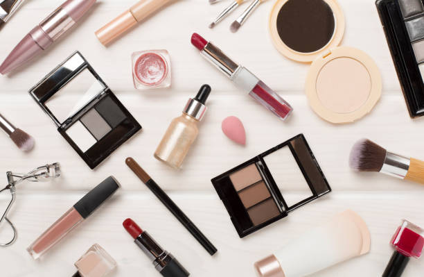 istock Flat lay with makeup products and tools on wooden background 2160497480