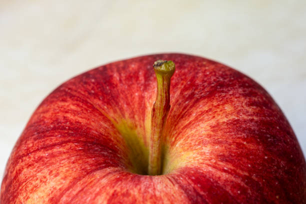 Gala apples on a white cutting board.
