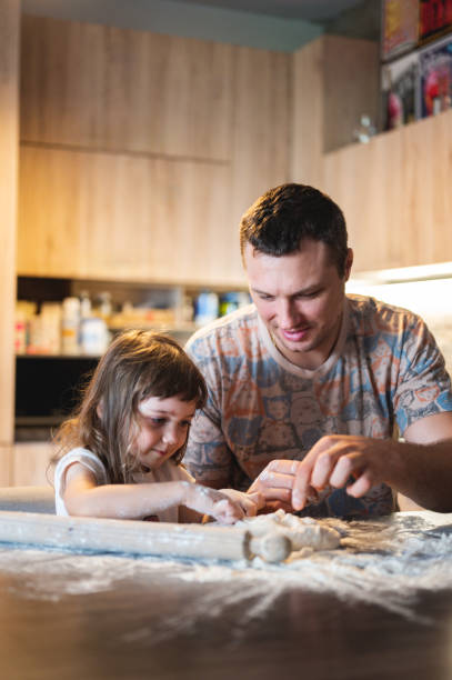 istock Father and daughter cooking 2160502890