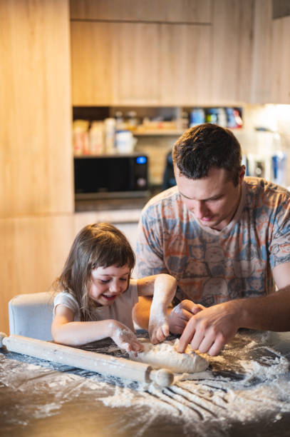 istock Happy family preparing pizza. 2160502899