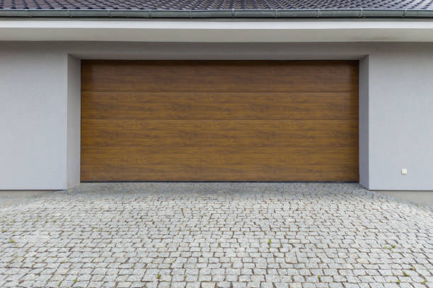 istock Modern Wooden Garage Door with Cobblestone Driveway 2160502941