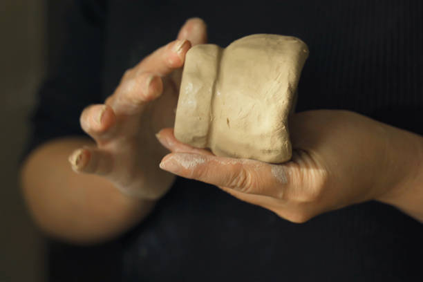 A woman makes a clay product with her hands - a ceramic pot. Close-up. Creative hobby.
