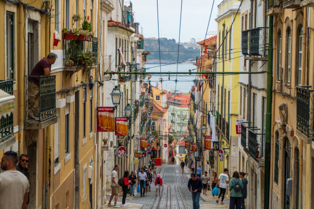 Tourists and locals alike enjoy the busy summer streets of Lisbon and the Calçada do Combro funicular in the capitol city of Portugal. June 28th 2024