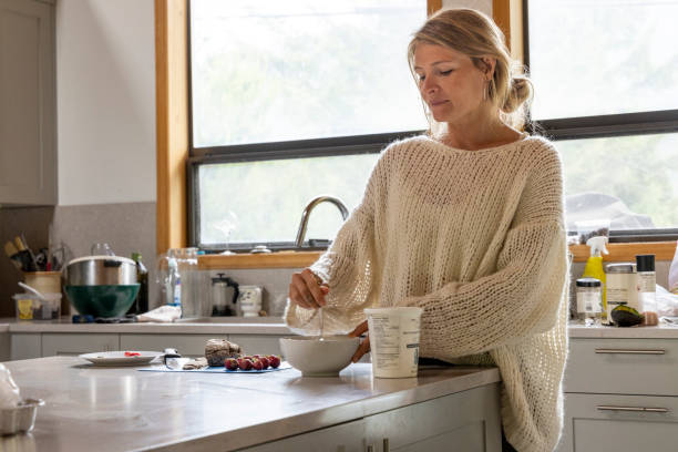 Young woman makes a healthy smoothie