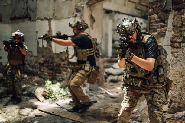 istock Front view of air soft player shooting with sniper rifle towards camera 2160510611