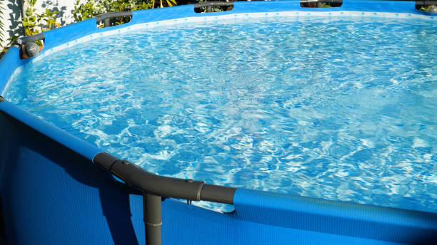 istock A round blue frame pool in the backyard in the early morning 2160510883