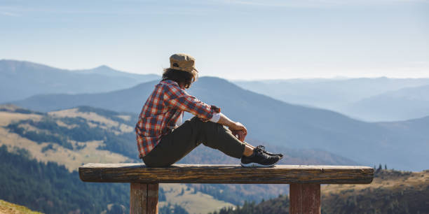 istock Man Resting on Bench with Scenic Mountain View in Ukraine 2160516952