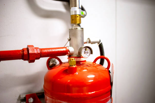 istock Fire extinguisher on the wall of a building, close-up 2160518399