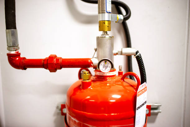istock Fire extinguisher on the wall of a building, close-up 2160518403