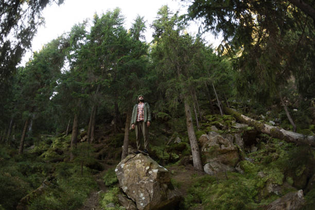 istock Man Standing on Rock in Forest: Nature Adventure and Exploration 2160519954