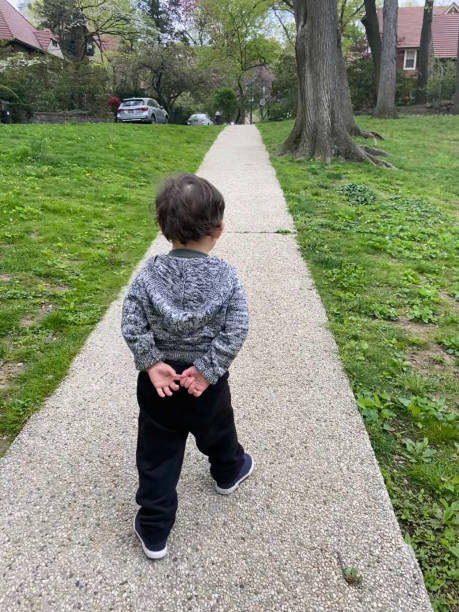 istock Boy walking at the park 2160521739