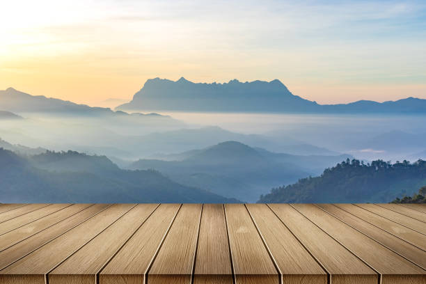istock Wooden table floor with mountain view and sunrise mist background 2160522882