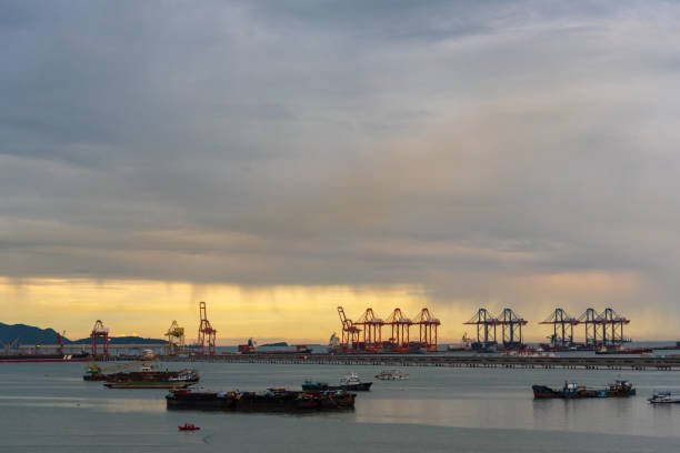 istock Logistic shipping quay boat in twilight sky night Engineering crane depot at logistic export terminal control. Warehouse freight background container yard loading quayside harbor port Logistics. 2160525844