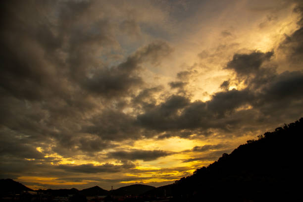 Scenic view dramatic beautiful sunset sky. Natural Sunset Sunrise on meadow silhouette shadow dark land. Vibrant dramatic sky on sunset, dawn, sunrise in Countryside. Landscape Colorful Sky At Sunset