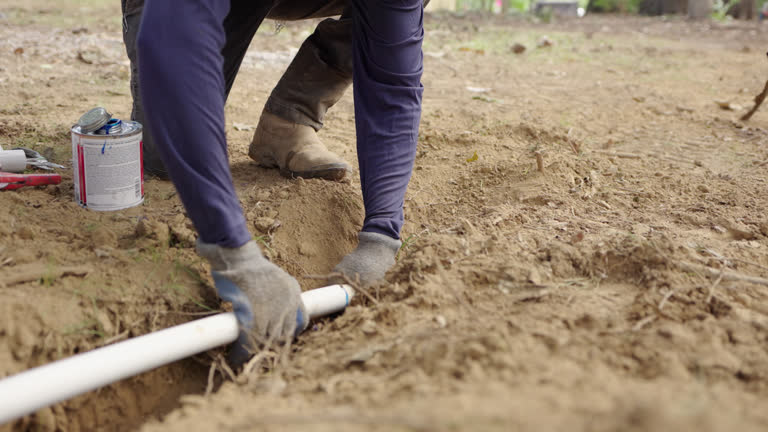 Irrigation Worker Connecting a Joint on a sprinkler pipe with PVC Cement