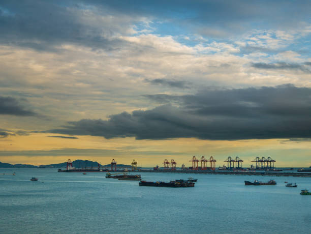 istock Logistic shipping quay boat in twilight sky night Engineering crane depot at logistic export terminal control. Warehouse freight background container yard loading quayside harbor port Logistics. 2160526396