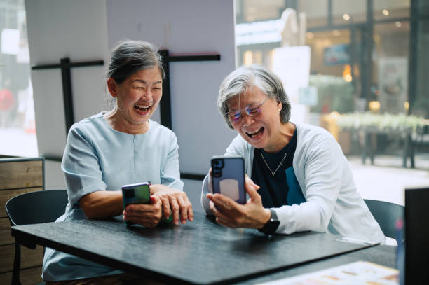 istock Two Mature women using phone to access a restaurant menu. 2160528705