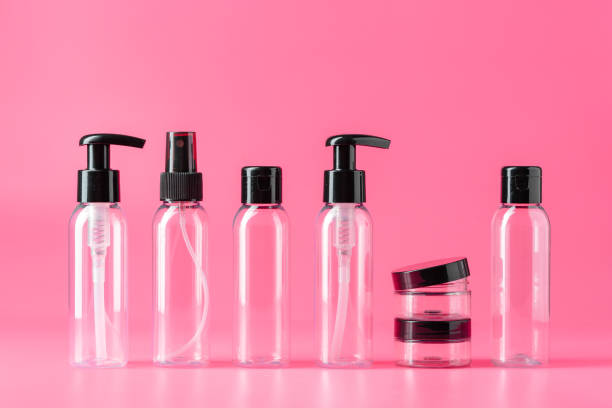 istock Six Clear Plastic Bottles With Black Caps on Pink Background 2160531492