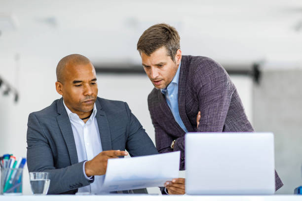 istock Male entrepreneurs analyzing business reports in the office. 2160534481