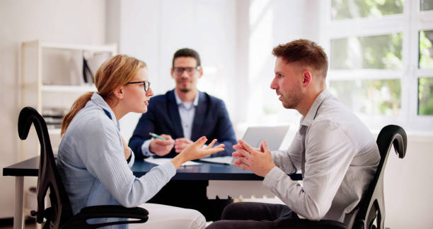 istock Professional lawyers mediating a tense argument between a young Hispanic couple 2160534794