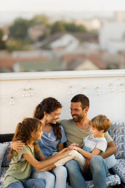 istock Happy family talking while relaxing on a patio. 2160534877