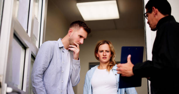 istock Bailiff speaking to a distressed couple 2160535106