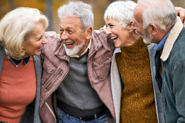 istock Cheerful senior friends talking embraced in nature. 2160535263