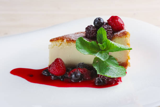 istock Cheesecake with berries sauce and green mint leaf. 2160536181