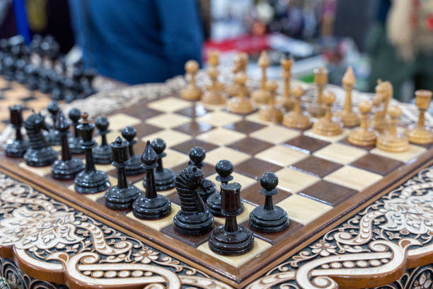 istock A wooden chess board with black and white pieces on it 2160536795