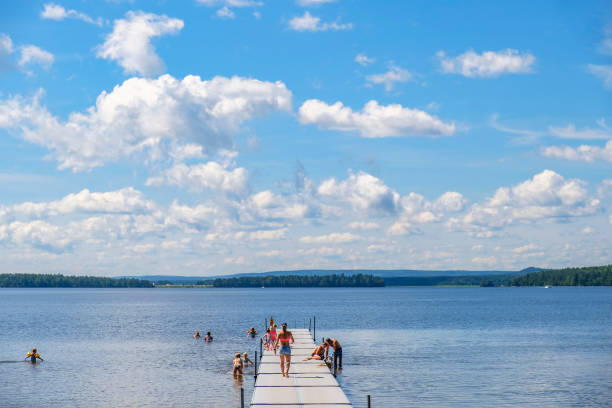 Karlsborg, Sweden-July, 2020: Jetty with bathing children in a lake