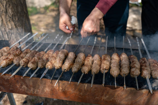 istock A man is cooking meat on a grill 2160538078