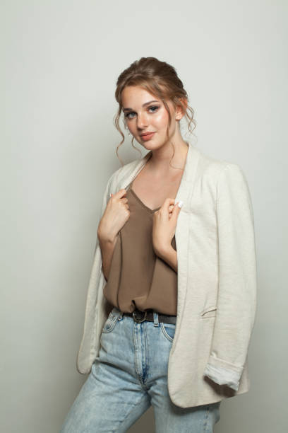 istock Cute casual model woman wearing light jacket standing against white studio wall background 2160538279