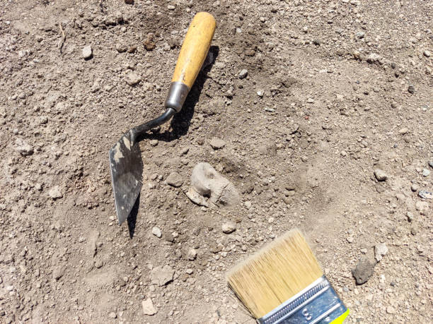 istock Professional Archaeological excavations, archaeologists work, dig up an ancient clay artifact with special tools in soil 2160542322