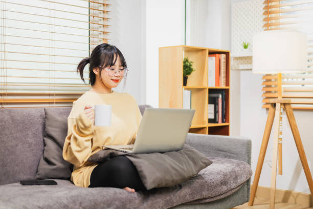 istock Woman working at home holding coffee cup in hand. 2160542394