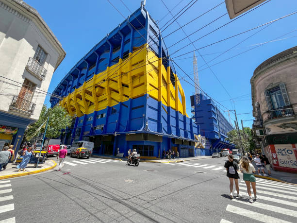 Buenos Aires, Argentina - November 24, 2023: Street view of Boca Juniors stadium on corner in Buenos Aires. People are pictured on the sidewalks.