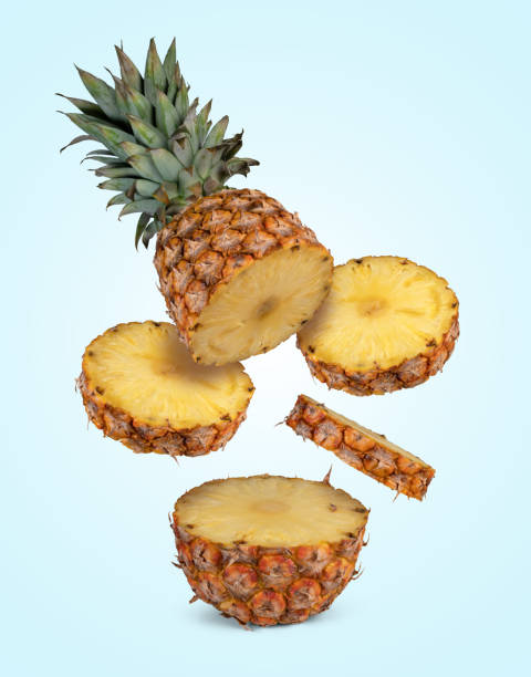 istock One fresh flying pineapple cut into slices isolated on blue summer background 2160545781