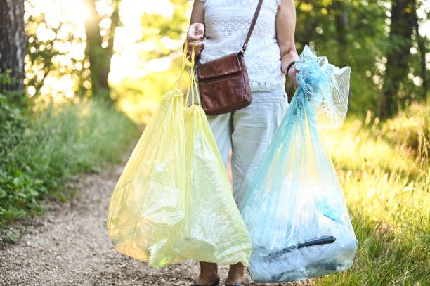 istock collecting trash in parkland. 2160549821