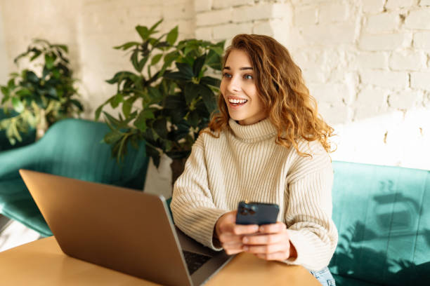 istock Woman freelancer using laptop while sitting in cozy cafe. 2160550509